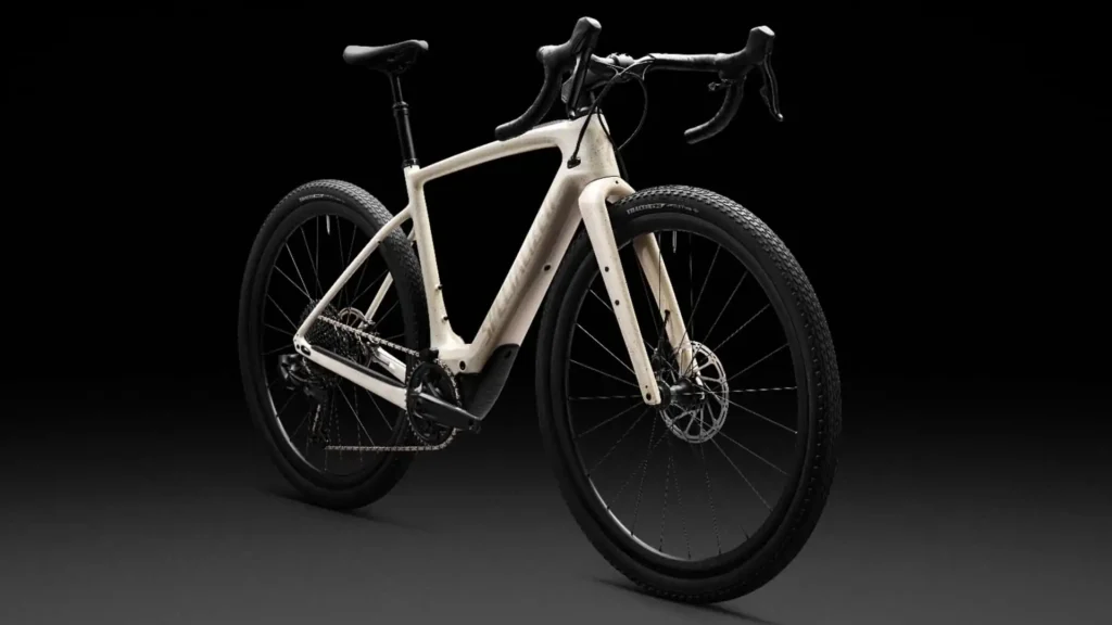 Specialized electric road bike in white showcased in a studio setup.
