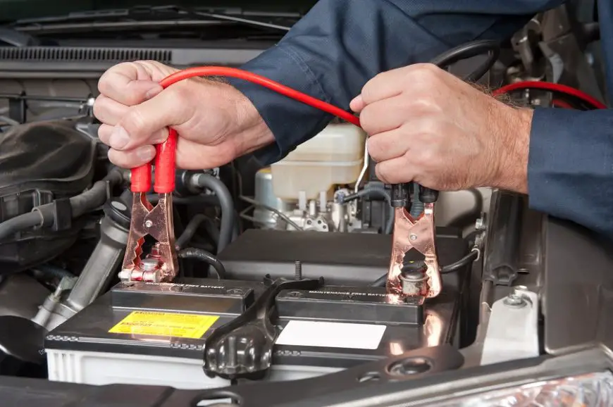 How to Jump Start a Car by connecting red and black jumper cables to a dead car battery