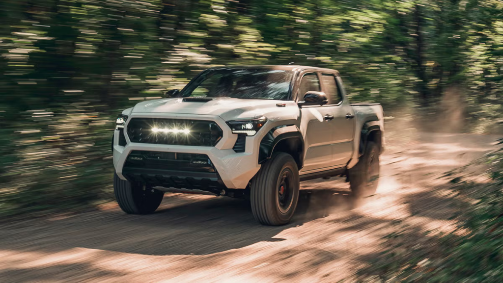 White 2026 Toyota Tacoma TRD model navigating dirt trail