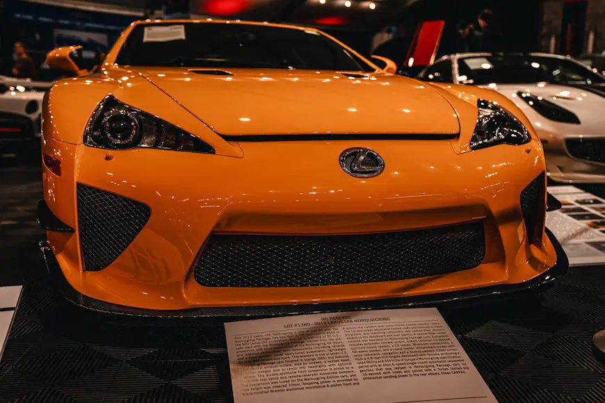 Striking orange Lexus LFA parked under vibrant lighting