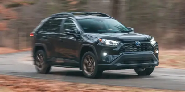 Black 2025 Toyota Hybrid SUV driving on a forest road Introducing Best Hybrid SUV