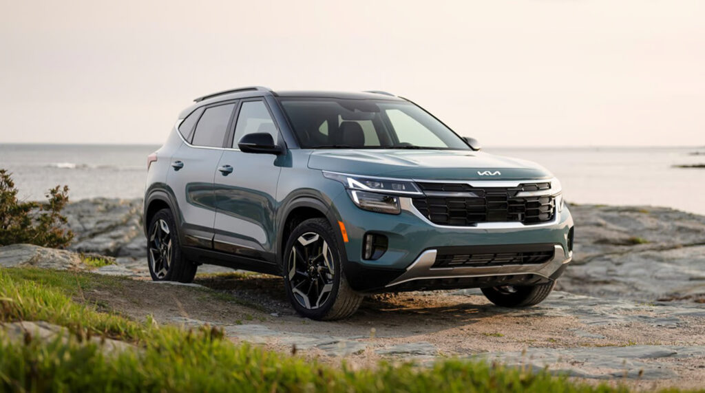 2025 Kia Seltos SUV parked by a scenic seaside.