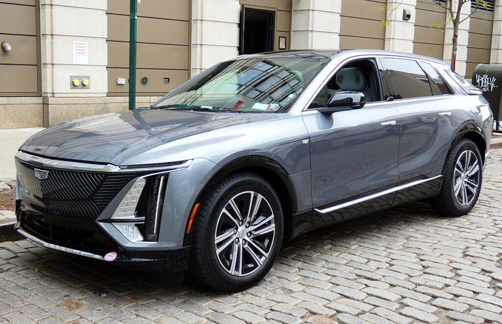 Cadillac Lyriq side view with LED grille, showcasing sleek luxury EV design.