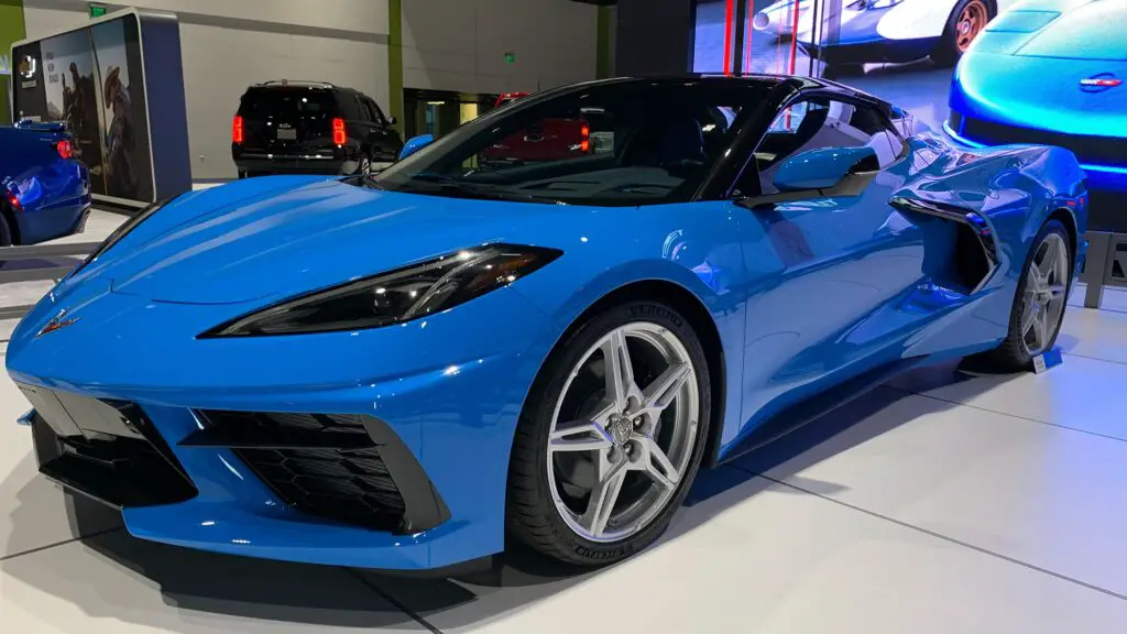 Chevrolet Corvette C8 Stingray side view at an auto show display, highlighting design details of the chevrolet corvette cx concept inspired model.