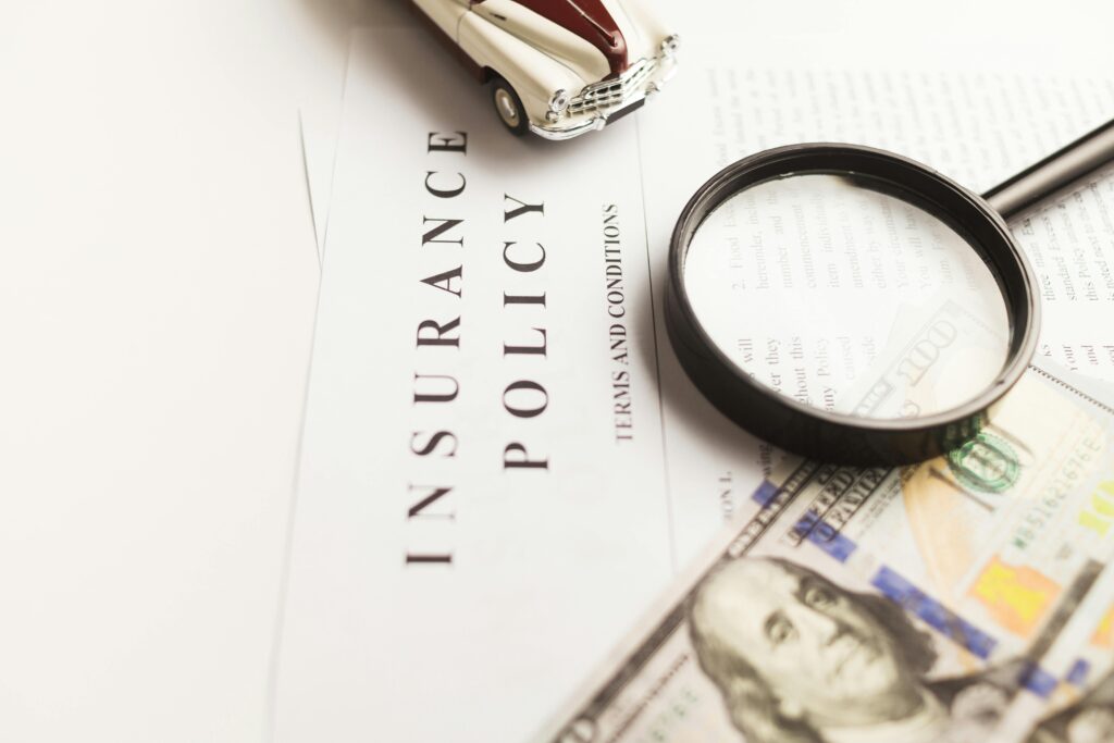 GAP Insurance Explained the policy papers with money and magnifying glass.