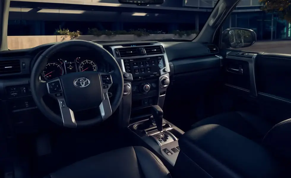 The Toyota 4Runne,r has leather seats, a digital-analog instrument cluster, a rearview camera, and a center touchscreen for entertainment.