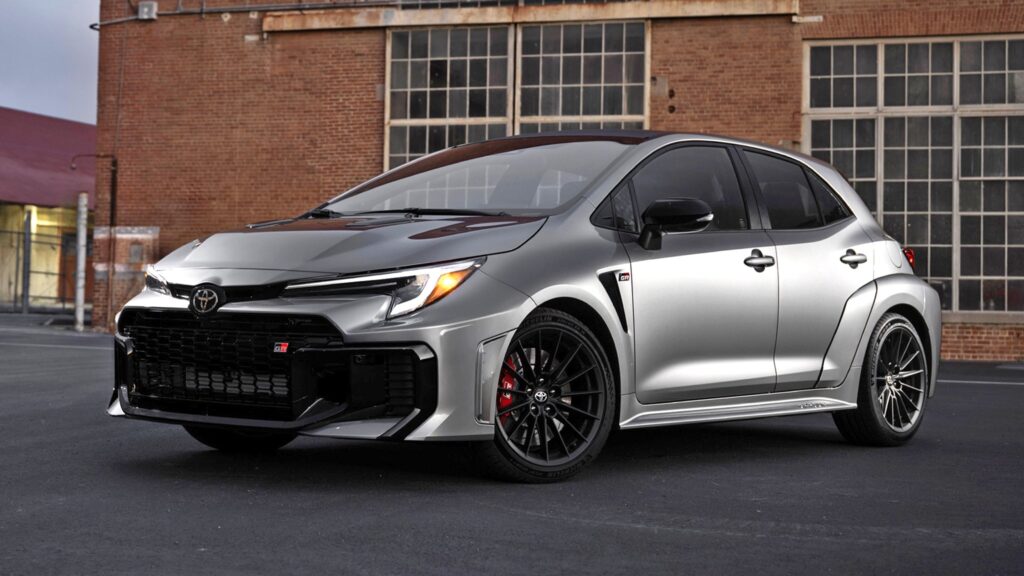 2026 Toyota GR Corolla front view with silver paint, sporty grille, and black alloy wheels.