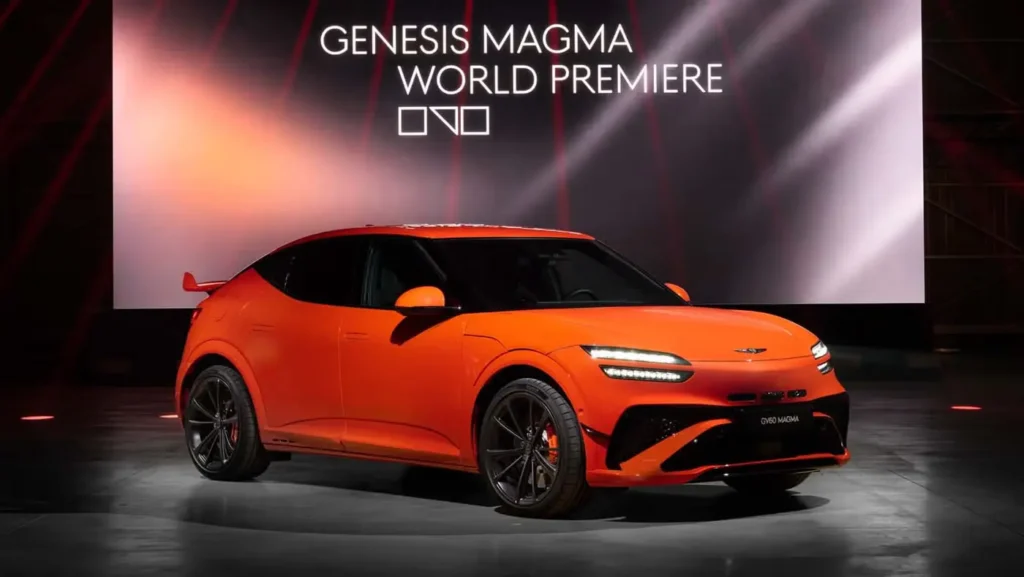 Side view of the 2027 Genesis GV60 Magma EV in bright Magma Orange during its world premiere event.